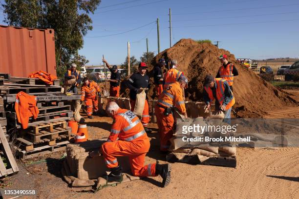 Volunteer State Emergency Service workers pack sandbags in preparation for major flooding on November 16, 2021 in Forbes, Australia. Residents in...
