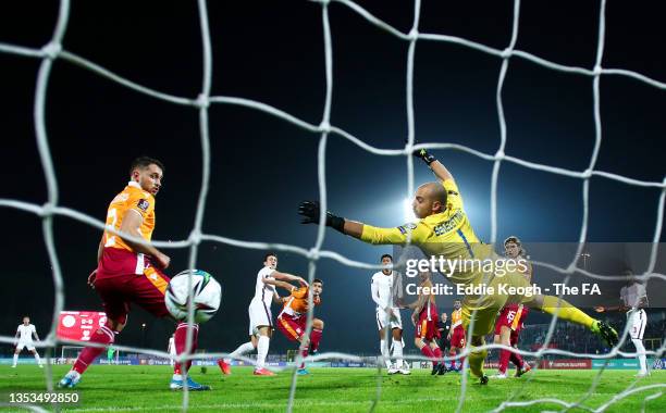 Harry Maguire of England scores their team's first goal past Elia Benedettini of San Marino during the 2022 FIFA World Cup Qualifier match between...