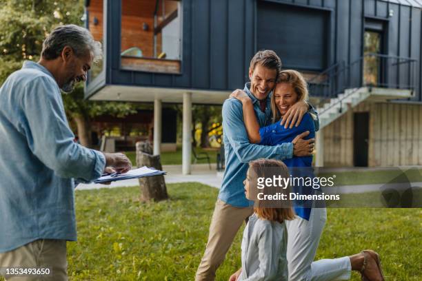 happy family made deal with real estate agent about buying new house - deal signing stockfoto's en -beelden