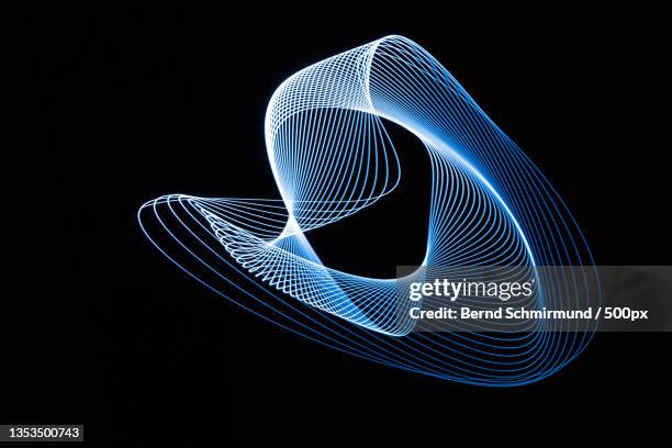 close-up of light painting against black background - lichtspur stock-fotos und bilder