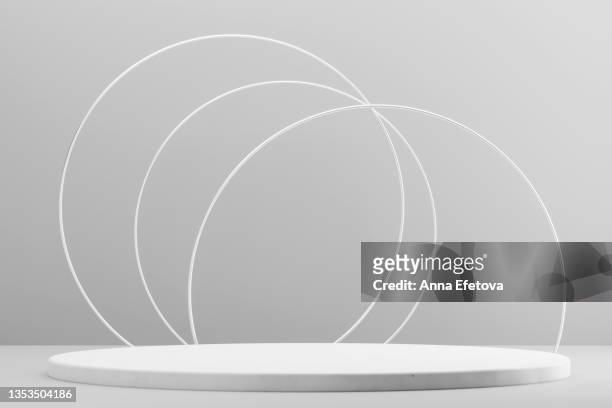 round white ceramic podium on gray background with three white circle frames. perfect platform for showing your products. three dimensional illustration - award pedestal stock pictures, royalty-free photos & images