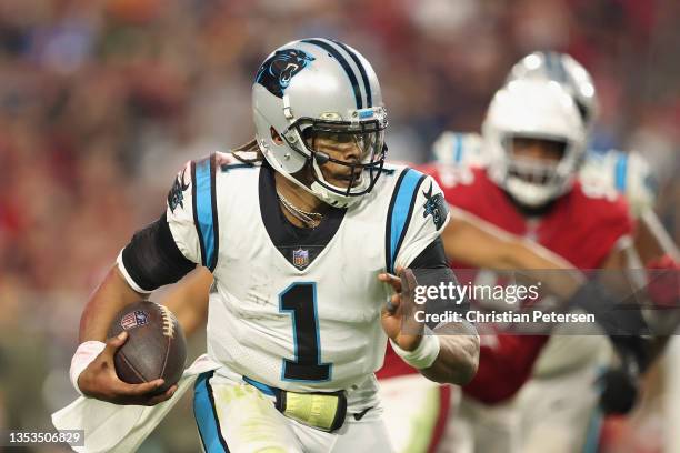 Quarterback Cam Newton of the Carolina Panthers scrambles with the football against the Arizona Cardinals during the fourth quarter of the NFL game...