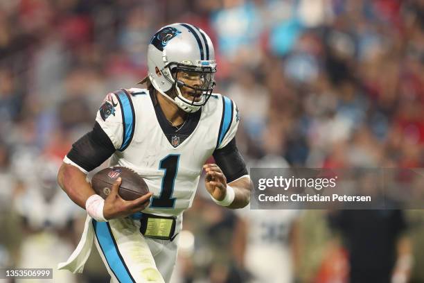 Quarterback Cam Newton of the Carolina Panthers scrambles with the football against the Arizona Cardinals during the fourth quarter of the NFL game...