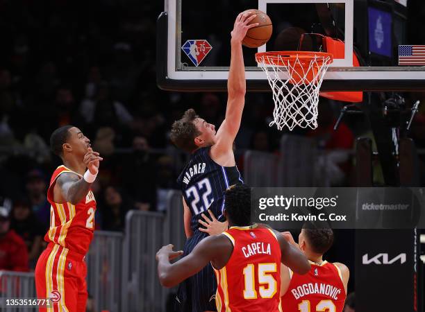 Franz Wagner of the Orlando Magic dunks against John Collins, Clint Capela, and Bogdan Bogdanovic of the Atlanta Hawks during the first half at State...