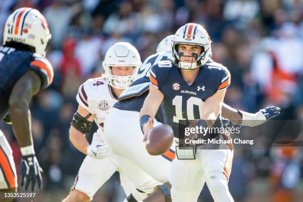 Quarterback Bo Nix of the Auburn Tigers pitches the ball to running back Tank Bigsby of the Auburn Tigers during the third quarter of their game...