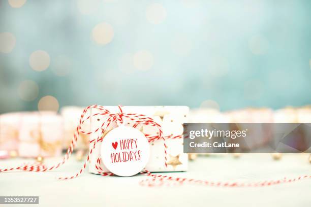 bright christmas background with happy holidays message on christmas gift - cat white background stock pictures, royalty-free photos & images