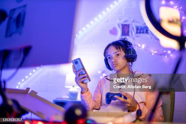 teenage female gamer playing at night - adhd stockfoto's en -beelden