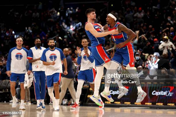 Kentavious Caldwell-Pope and Deni Avdija of the Washington Wizards celebrate after Pope hit a three pointer in the fourth quarter against the New...