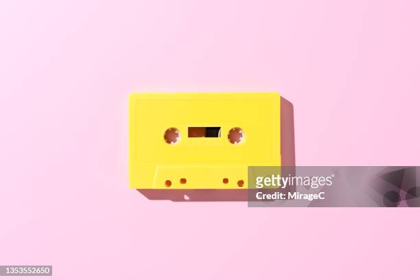 audio cassette tape on pink - music history stock pictures, royalty-free photos & images