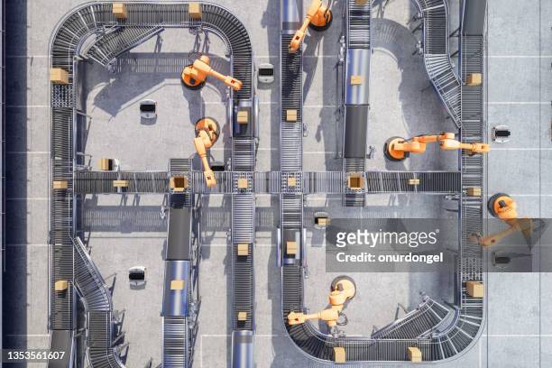 top view of robotic arms working on conveyor belt in automatic warehouse - high angle view stock pictures, royalty-free photos & images