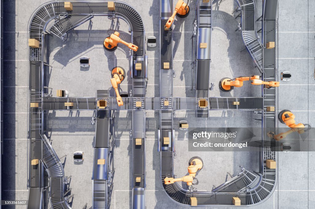 Top View Of Robotic Arms Working On Conveyor Belt In Automatic Warehouse