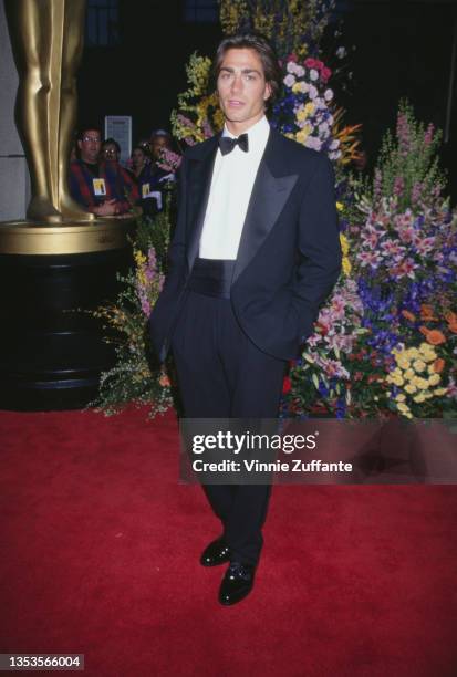 American actor and model Michael Bergin, wearing a tuxedo and bow tie, attends the 68th Annual Academy Awards at Dorothy Chandler Pavilion in Los...