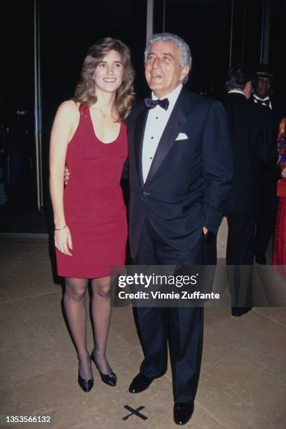 American schoolteacher Susan Crow, wearing a red dress, and American singer Tony Bennett, wearing a black tuxedo and bow tie, attend the 10th Annual...