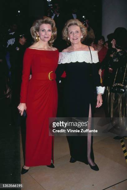 American actress Candice Bergen, wearing a red evening dress, and her mother, American actress Frances Bergen, wearing a black evening dress with...