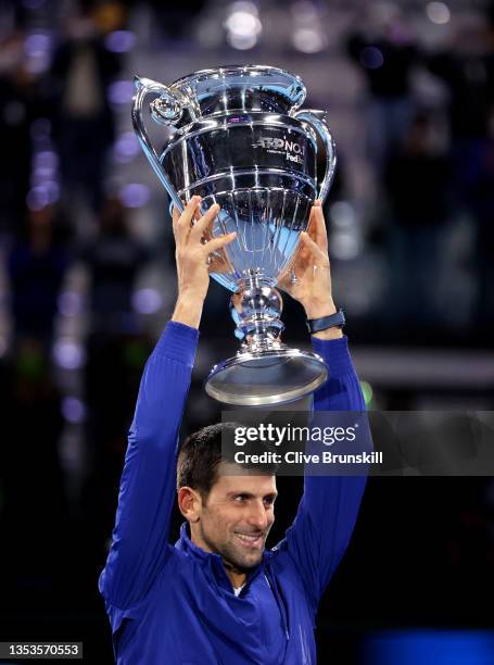 Novak Djokovic of Serbia holds aloft the world number 1 trophy for his 7th consecutive year during Day Two of the Nitto ATP World Tour Finals at Pala...