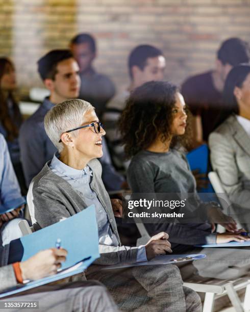 large group of entrepreneurs on a seminar in board room. - training course stock pictures, royalty-free photos & images