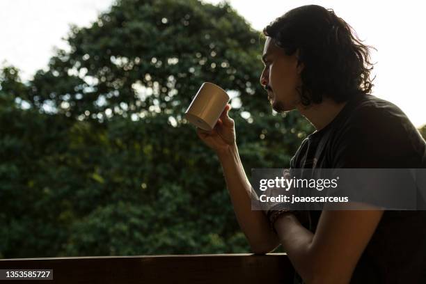 man drinking coffee or tea on porch amid nature - istock images stock pictures, royalty-free photos & images