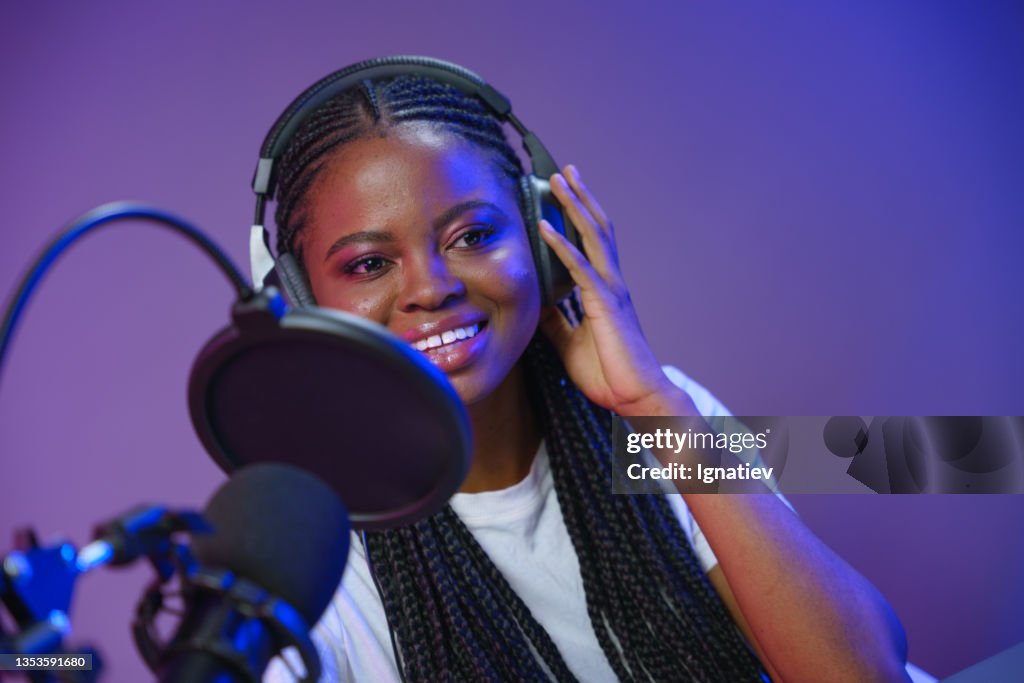 Blogger with a microphone is in the studio