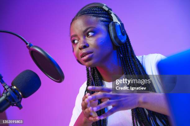 young lady is sitting in front of microphone - radio dj stockfoto's en -beelden