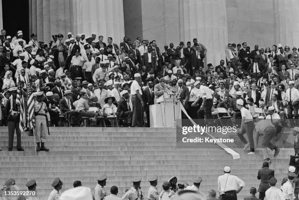 Speaker tries to make up for, after accidentally unrolling a parchment with a speech, helped by marshals, at the March on Washington for Jobs and...