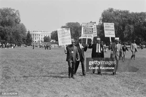 Group of men holding placards during the March on Washington for Jobs and Freedom, Washington DC, US, 28th August 1963. The White House in the...