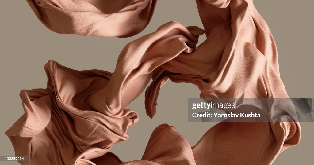 Cotton fabrick flowing by wind on beige background stock photo