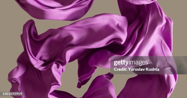 cotton fabrick flowing by wind on beige background stock photo - purple fabric stock pictures, royalty-free photos & images