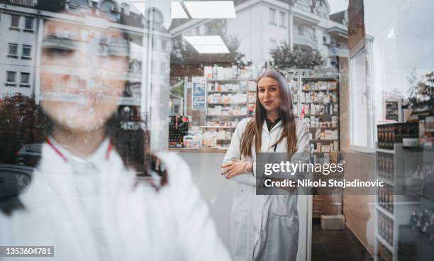 薬局店へようこそ - 女性薬剤師 ストックフォトと画像