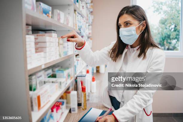 pharmacist checking medicine - pharmacy mask stock pictures, royalty-free photos & images