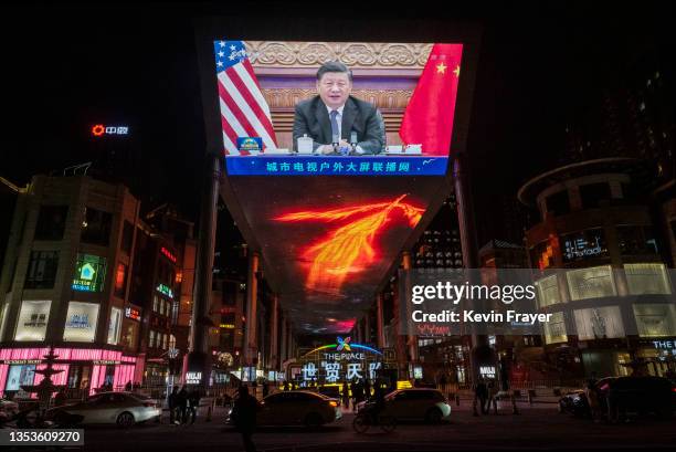 Large screen displays China's President Xi Jinping during a virtual summit with United States President Joe Biden, not seen, during the evening CCTV...