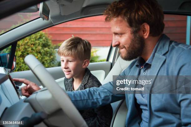 father and son in a car searching on gps - co pilot stock pictures, royalty-free photos & images