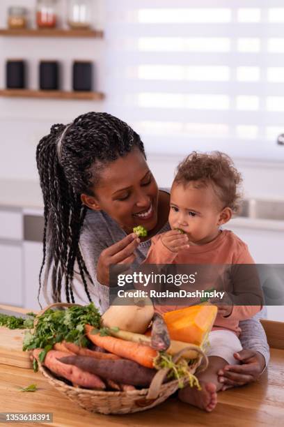 mother and baby daughter preparing food. - baby chef stock pictures, royalty-free photos & images