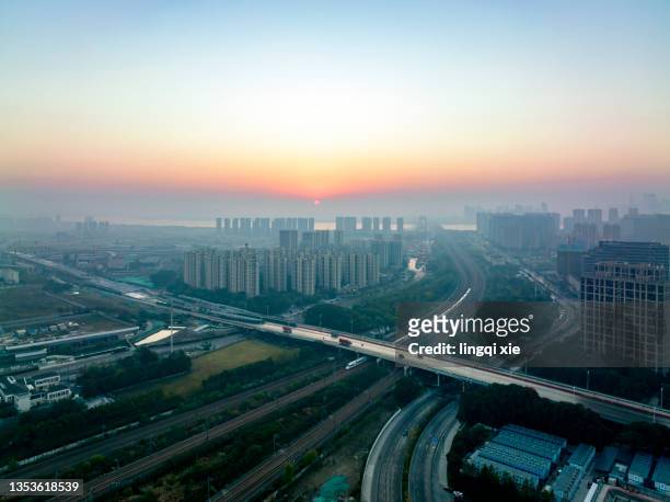 aerial photography of hangzhou, china, high-speed train passing through the city in the morning fog - railway tracks sunset stock pictures, royalty-free photos & images