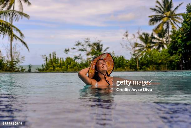 woman in infinity pool. - eco tourism stock pictures, royalty-free photos & images