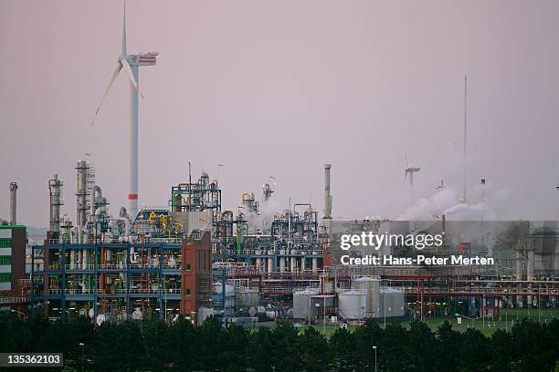 refinery and wind turbine - brunsbuttel stock pictures, royalty-free photos & images
