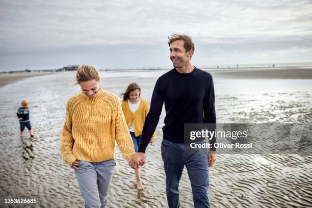 family walking together on the beach at low tide - german north sea region bildbanksfoton och bilder