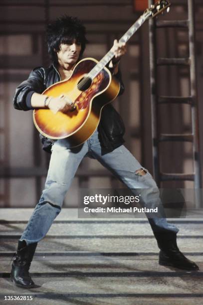 Rolling Stones guitarist Ronnie Wood performing on the set of the music video for 'One Hit ', England, May 1986.