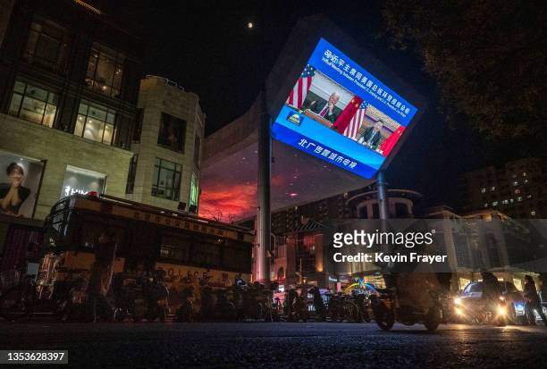 Large screen displays United States President Joe Biden, left, and China's President Xi Jinping during a virtual summit during the evening CCTV news...