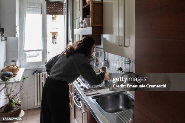Sara Mancabelli uses the bain-marie technique to melt beeswax and castor oil while self producing lip balm on November 16, 2021 in Milan, Italy. Sara...