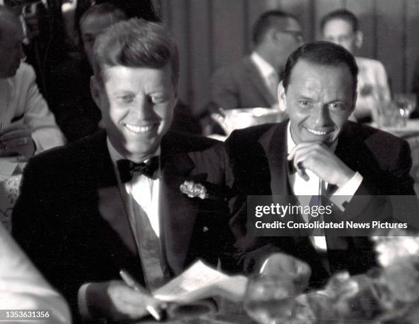 Senator John F Kennedy and entertainer Frank Sinatra attend a black tie, Democratic Committee Dinner at the Beverly Hilton Hotel, Los Angeles,...