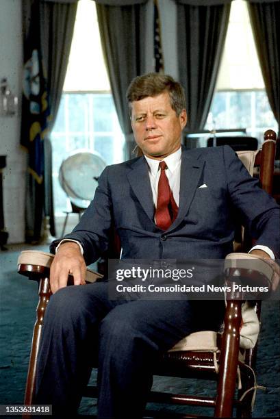 President John F Kennedy sits in a rocking chair in the White House's Oval Office, Washington DC, 1963.