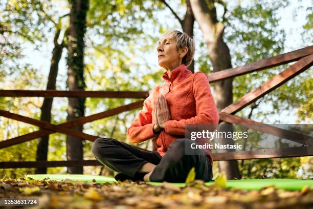 senior woman practicing yoga - tai chi shadow stock pictures, royalty-free photos & images