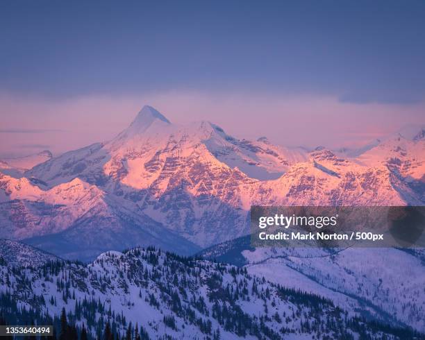 scenic view of snowcapped mountains against sky during sunset,glacier national park,montana,united states,usa - montana moody sky stock pictures, royalty-free photos & images