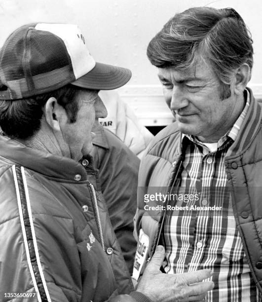 Driver Bobby Allison, right, talks with his brother Donnie Allison in the speedway garage prior to the start of the 1982 Daytona 500 stock car race...