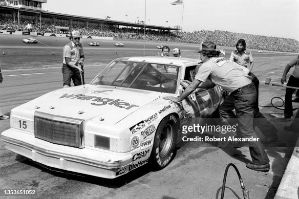 Driver Dale Earnhardt, Sr. Makes a pit stop during the running of the 1982 Firecracker 400 stock car race at Daytona International Speedway in...
