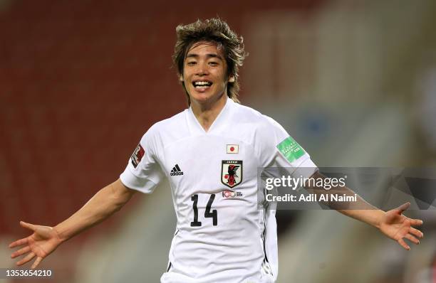 Junya Ito of Japan celebrates after scoring their side's first goal during the FIFA World Cup Asian Qualifier final round Group B match between Oman...