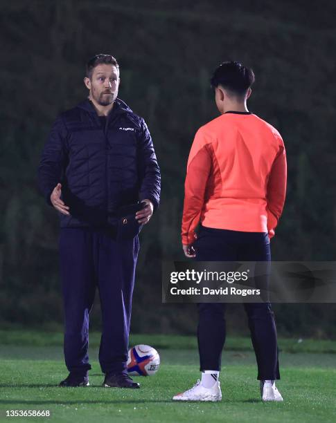 England fly half Marcus Smith talks with Jonny Wilkinson during an England training session ahead of their upcoming match against South Africa on...