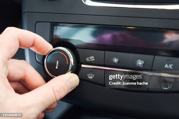 person hand setting the temperature of air conditioner in the car. - air conditioner car stock pictures, royalty-free photos & images