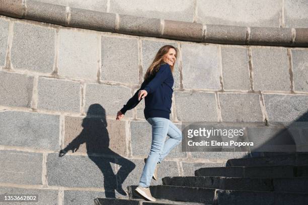 young confidence woman wearing casual clothes walking at the urban staircase up and down - nach oben stock-fotos und bilder