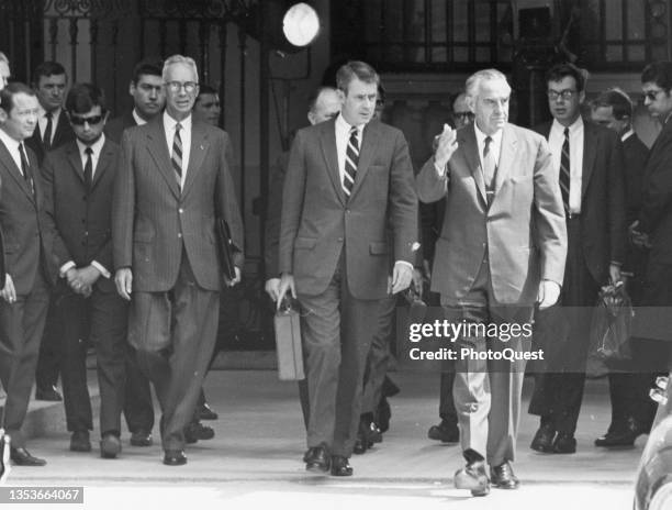 Members of the American delegation emerge from the Center of International Conferences after their second official meeting with North Vietnamese...